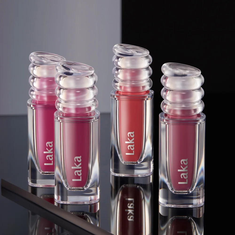 Four Laka Maxi Glayer Tint tubes on a reflective black surface